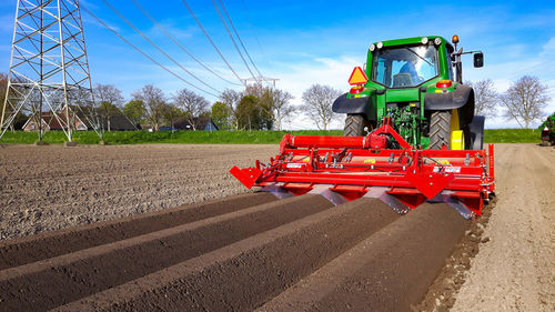 Tractor on field against sky