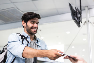 Smiling man checking in at airport