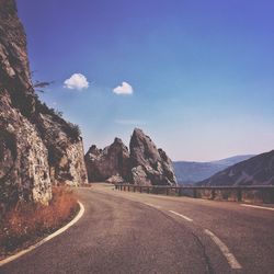 Road amidst mountains against sky