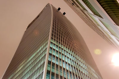 Low angle view of modern buildings against sky during sunset