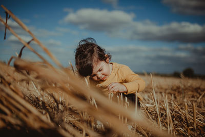 Girl crouching on plants