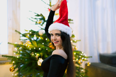 Portrait of woman with christmas tree