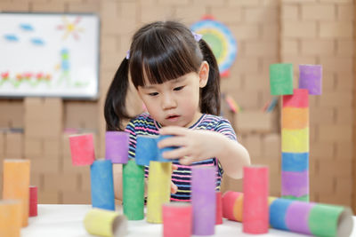 Young girl making craft for home schooling