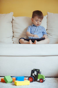 Boy playing with toy car