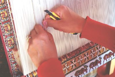 Woman weaving carpet in workshop