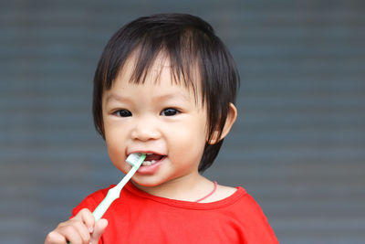 Portrait of cute baby girl brushing teeth