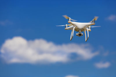 Low angle view of quadcopter against sky