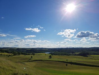 Scenic view of landscape against sky on sunny day