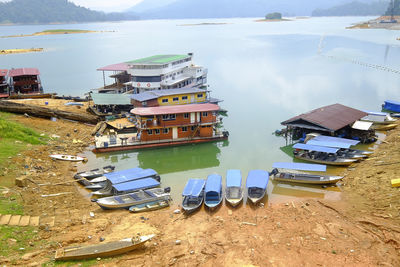 High angle view of buildings by lake against sky