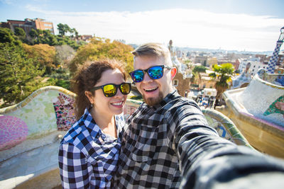 Portrait of happy young couple in city