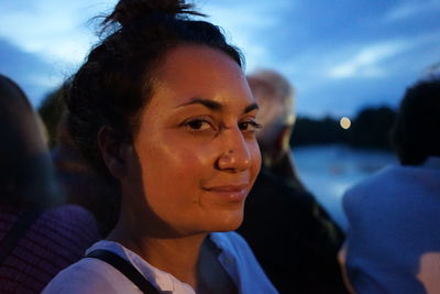 Portrait of young woman against sky