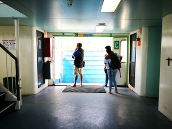 People walking in corridor of building