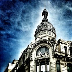 Low angle view of building against cloudy sky