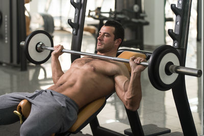 Muscular man exercising in gym