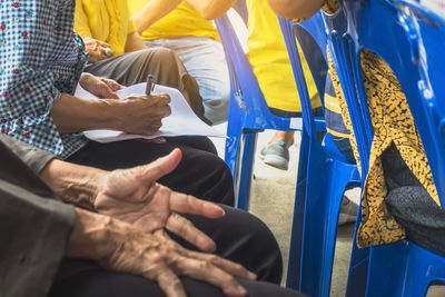 Low section of people sitting on bench