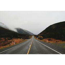 Country road leading towards mountains