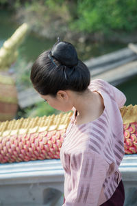 High angle view of woman standing by railing on staircase