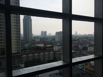 High angle view of buildings seen through window