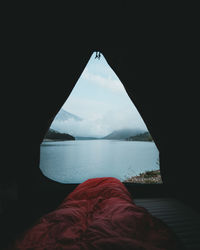 Lake against sky seen through tent