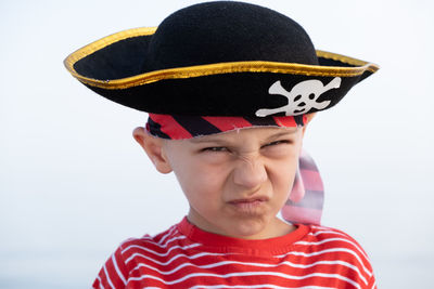 Portrait of boy wearing hat against white background