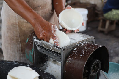 Midsection of person preparing food at market