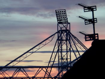 Low angle view of silhouette built structure against sky