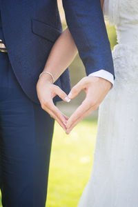 Midsection of couple holding hands