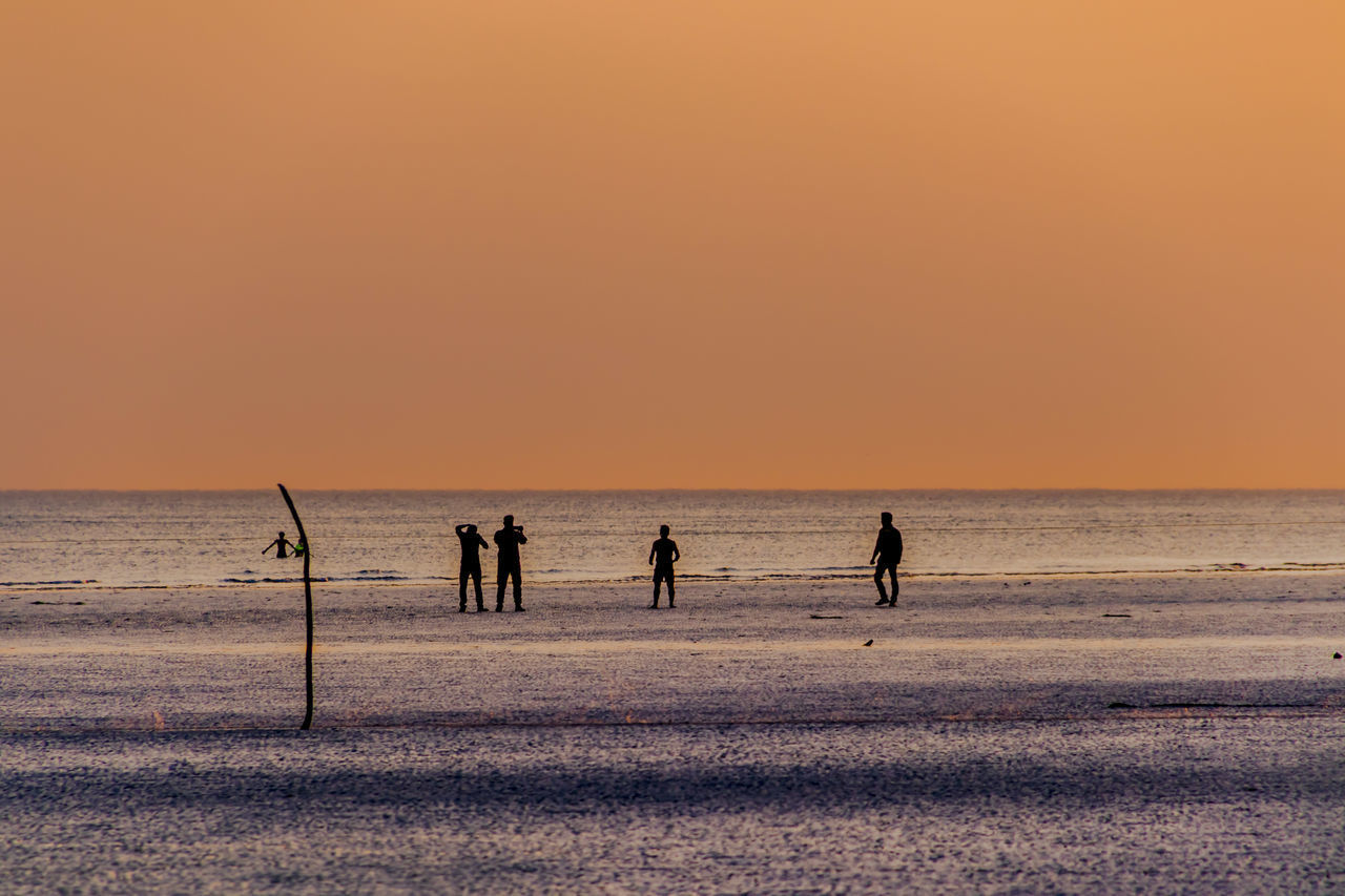 SILHOUETTE PEOPLE ON BEACH DURING SUNSET