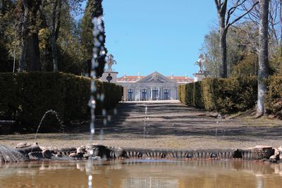 View of lake by buildings against sky