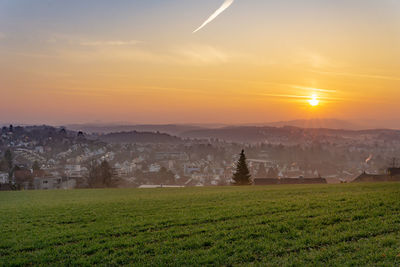 Scenic view of field against sky during sunset