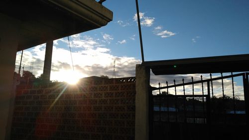 Sun shining through fence