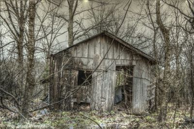 Abandoned house with trees in background