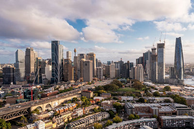 Buildings in city against cloudy sky