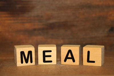 Close-up of information sign on table