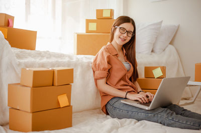 Woman using mobile phone at home