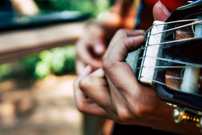 Close-up of hand playing guitar