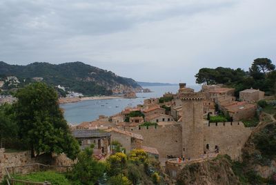 View of town against cloudy sky