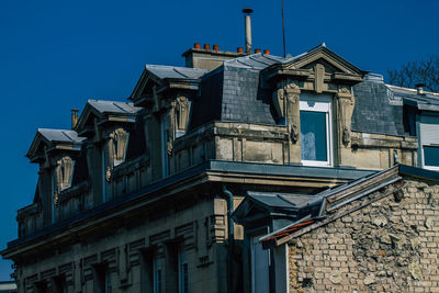 Low angle view of old building against clear blue sky