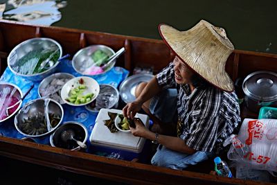 Midsection of man sitting on table