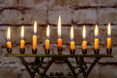 Close-up of lit candles in temple