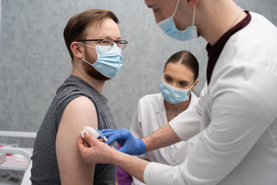 Side view of female doctor examining patient