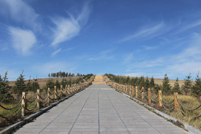 The next road under the blue sky leads to the top of the mountain