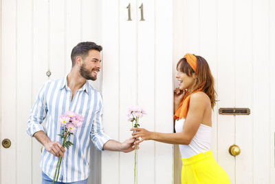 Young couple holding flowers