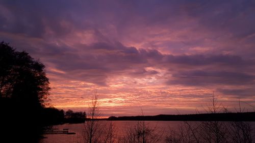 Scenic view of lake against orange sky