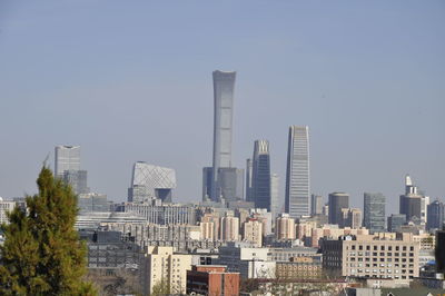 Buildings in city against clear sky