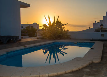 View of swimming pool at sunset