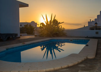 View of swimming pool at sunset