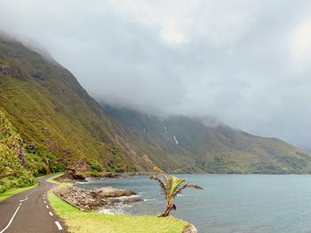 Road by lake against sky