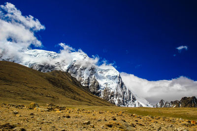 Scenic view of snowcapped mountains against blue sky
