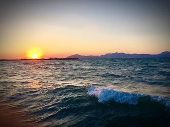 Scenic view of sea against clear sky during sunset